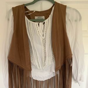 Long sleeve white shirt; brown sleeveless blazer